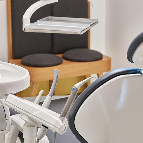 Geräte zur Behandlung beim Zahnarzt, ein Waschbecken und ein Behandlungsstuhl.